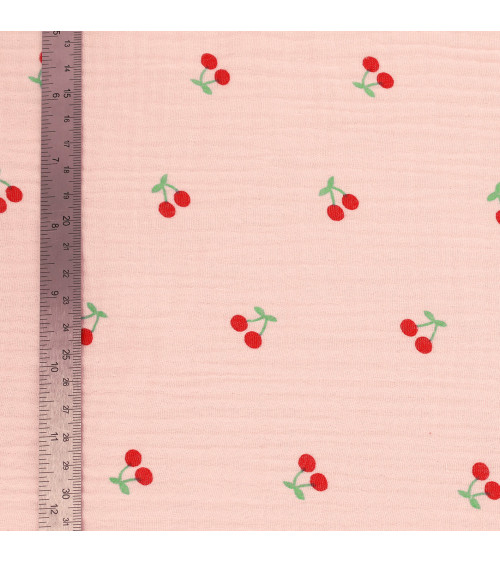Cherry printed double gauze fabric with pink background by the meter