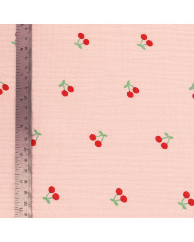 Cherry printed double gauze fabric with pink background by the meter