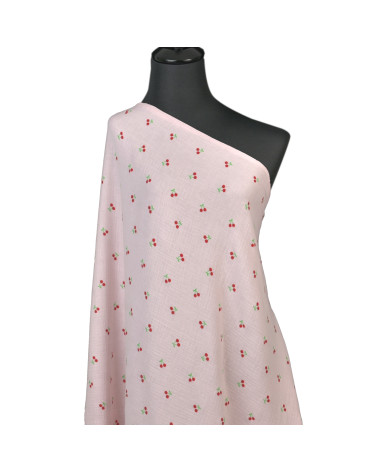 Tela gasa doble con estampado de cerezas y fondo rosa por metros