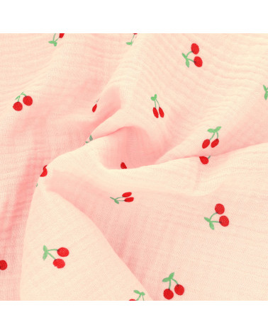 Tela gasa doble con estampado de cerezas y fondo rosa por metros