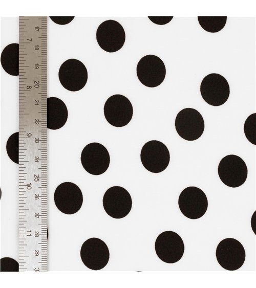 Tela elástica súper suave estampada con lunares negros sobre fondo blanco 150 cm por metro